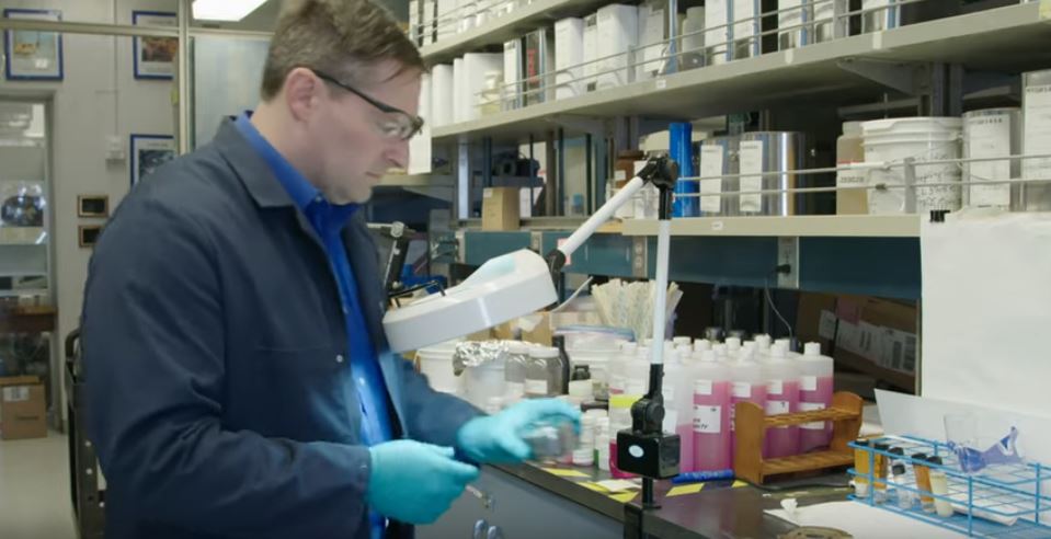 man in lab testing oil